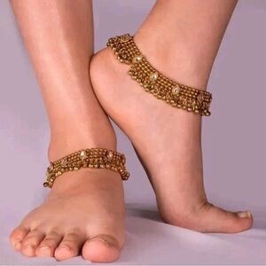 Gold anklets with and a pair of golden pearl and kundan earrings